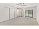 Bedroom with carpeted flooring, sliding glass door, and built-in closet at 7385 E Pleasant Run, Scottsdale, AZ 85258