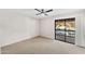 Carpeted bedroom with sliding glass door access to a private balcony at 7385 E Pleasant Run, Scottsdale, AZ 85258