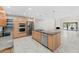 Modern kitchen with stainless steel appliances, an island with sink, and ample counter space at 7385 E Pleasant Run, Scottsdale, AZ 85258