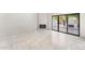 Living room with fireplace, sliding doors, and access to the backyard patio at 7385 E Pleasant Run, Scottsdale, AZ 85258