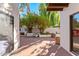 Patio view with lush plants, a fireplace, and access to home's interior at 7385 E Pleasant Run, Scottsdale, AZ 85258