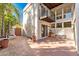 Tiled patio area with access to the home's entrance and a second-story balcony at 7385 E Pleasant Run, Scottsdale, AZ 85258