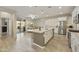 Modern kitchen featuring white cabinets, stainless steel appliances, and a large island overlooking the dining area at 10314 E Texas Ave, Mesa, AZ 85212