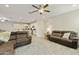 Open concept living room with brown sectional sofa and view of the kitchen at 10314 E Texas Ave, Mesa, AZ 85212