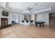 Basement with bar, pool table, fireplace, and hardwood floors at 11328 E Dreyfus Ave, Scottsdale, AZ 85259