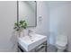 Modern bathroom with a white vanity, patterned tile floor, and stylish mirror at 11328 E Dreyfus Ave, Scottsdale, AZ 85259