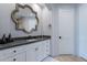Bathroom with white vanity, dark countertop, and decorative mirror at 11328 E Dreyfus Ave, Scottsdale, AZ 85259