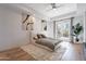 Bedroom with comfortable bed, area rug, potted plant, and outdoor access at 11328 E Dreyfus Ave, Scottsdale, AZ 85259