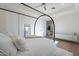 Modern bedroom with a canopy bed, wood floors, and white walls at 11328 E Dreyfus Ave, Scottsdale, AZ 85259