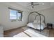 Bright bedroom with wood floors, canopy bed, and large windows overlooking scenic views at 11328 E Dreyfus Ave, Scottsdale, AZ 85259