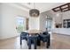 Dining area with round table, unique chandelier, and scenic views at 11328 E Dreyfus Ave, Scottsdale, AZ 85259