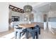 Dining area with a unique beaded light fixture, wooden table, and plush chairs at 11328 E Dreyfus Ave, Scottsdale, AZ 85259