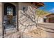 Intricate black iron front door with decorative glass and paver walkway at 11328 E Dreyfus Ave, Scottsdale, AZ 85259