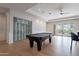Game room with pool table, wine cellar, and outdoor views at 11328 E Dreyfus Ave, Scottsdale, AZ 85259