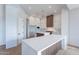 Bright, open kitchen featuring white cabinets, an island with seating, and wood accents at 11328 E Dreyfus Ave, Scottsdale, AZ 85259