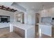 Open-concept kitchen and living area with wood floors and beamed ceilings at 11328 E Dreyfus Ave, Scottsdale, AZ 85259