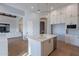 Stylish kitchen boasts an island with sink, white cabinets, and hardwood floors at 11328 E Dreyfus Ave, Scottsdale, AZ 85259