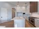 Contemporary kitchen with white cabinetry, a large island, and stainless steel appliances at 11328 E Dreyfus Ave, Scottsdale, AZ 85259