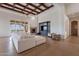 Spacious living room with wood beamed ceilings, fireplace, built-in entertainment center, and large windows at 11328 E Dreyfus Ave, Scottsdale, AZ 85259