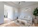 Cozy living area with a white couch, large windows, and wood floors at 11328 E Dreyfus Ave, Scottsdale, AZ 85259