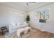Cozy living room with a white couch, wood floors, and large windows at 11328 E Dreyfus Ave, Scottsdale, AZ 85259