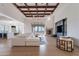 Living room with wood beams, fireplace, white sectional sofa, and desert views at 11328 E Dreyfus Ave, Scottsdale, AZ 85259