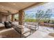 Spacious covered patio with seating area overlooking the pool and desert landscape at 11328 E Dreyfus Ave, Scottsdale, AZ 85259