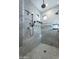Spacious walk-in shower with marble tile, multiple shower heads, and a built-in bench at 11328 E Dreyfus Ave, Scottsdale, AZ 85259