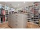 Large walk-in closet with built-in shelving, center island, and ample storage at 11328 E Dreyfus Ave, Scottsdale, AZ 85259