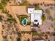 Bird's-eye view of a home, pool, and surrounding desert landscape at 12550 E Silver Spur St, Scottsdale, AZ 85259