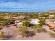 Aerial view of a sprawling home with a pool and desert landscaping at 12550 E Silver Spur St, Scottsdale, AZ 85259