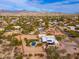 Aerial view showcasing a home with a pool, solar panels, and mountain views at 12550 E Silver Spur St, Scottsdale, AZ 85259