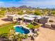 Aerial view of a home with a pool and desert landscape at 12550 E Silver Spur St, Scottsdale, AZ 85259