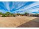Large backyard with empty space and partial view of the house at 12550 E Silver Spur St, Scottsdale, AZ 85259