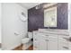 Updated bathroom with a stylish vanity and patterned wallpaper at 12550 E Silver Spur St, Scottsdale, AZ 85259