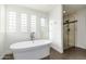 Luxurious bathroom with a freestanding tub and glass shower enclosure at 12550 E Silver Spur St, Scottsdale, AZ 85259