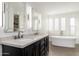 Elegant bathroom features a double vanity, soaking tub, and separate shower at 12550 E Silver Spur St, Scottsdale, AZ 85259