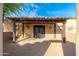 Elegant entry with a wood pergola and ornate iron doors at 12550 E Silver Spur St, Scottsdale, AZ 85259