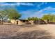 Brick driveway leads to a charming stucco home with mature trees at 12550 E Silver Spur St, Scottsdale, AZ 85259