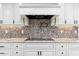 Modern kitchen with cooktop and white cabinets at 12550 E Silver Spur St, Scottsdale, AZ 85259