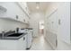 Laundry room with white cabinets, washer, dryer, and sink at 12550 E Silver Spur St, Scottsdale, AZ 85259