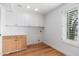Laundry room with wood cabinets and window with shutters at 12550 E Silver Spur St, Scottsdale, AZ 85259