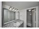 Spacious bathroom with gray vanity cabinet, granite countertop, and large mirror at 2121 W Royal Palm Rd # 1015, Phoenix, AZ 85021