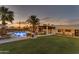 Landscaped backyard with pool, lawn, and sunset views at 2449 W Sunrise Dr, Phoenix, AZ 85041