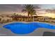 Freeform pool with night lighting and lounge chairs at 2449 W Sunrise Dr, Phoenix, AZ 85041