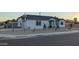 Exterior view of the home with a gray and white facade, landscaped yard, and street view at 2645 E Phelps Rd, Phoenix, AZ 85032