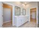 Modern bathroom with double vanity, large mirrors, and stylish fixtures at 28205 N 213Th Dr, Wittmann, AZ 85361