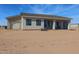 Exterior view of the back of the house, featuring a covered patio and attached garage at 28211 N 213Th Dr, Wittmann, AZ 85361