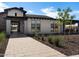 Inviting front walkway leads to a modern home with a combination of stucco, stone, and wood exterior at 3390 E Audrey Dr, San Tan Valley, AZ 85143