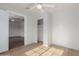 Bedroom with wood-look floors, ceiling fan, and a view to another room at 3622 W Sunland Ave, Phoenix, AZ 85041